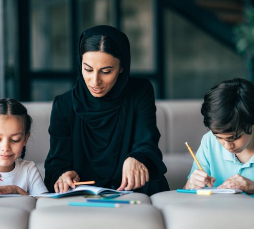 Traditional arabian family from Dubai spending time together at home. Concept about, emirati culture, parenthood, adoption and  family lifestyle